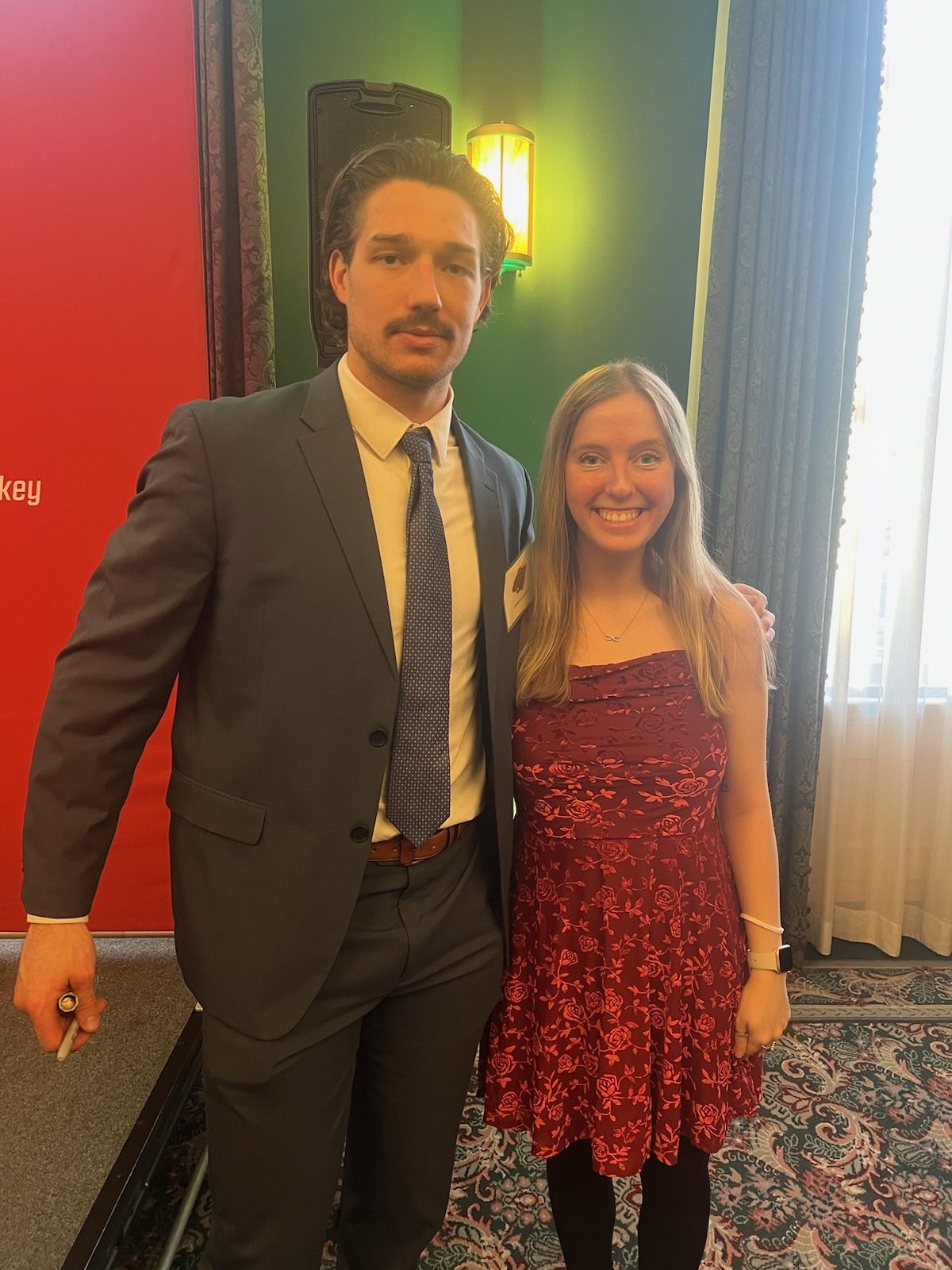 Sydney taking a picture with Brandon Duhaime during the Minnesota Wild Whiskey and Wine event